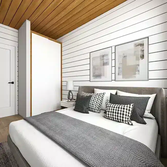 Modern barndominium master bedroom with shiplap walls and wood ceiling accents