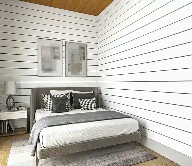 Modern barndominium bedroom with white shiplap walls and wood ceiling